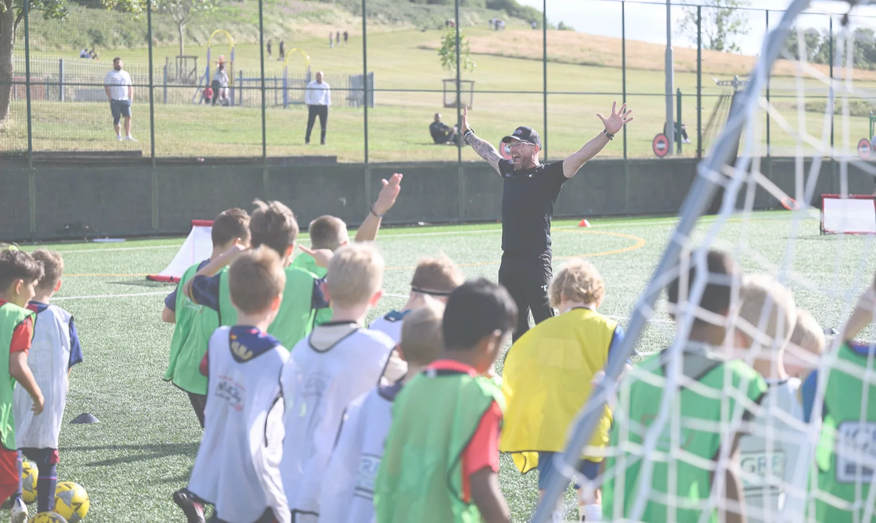 A coach leading a grassroots football training session